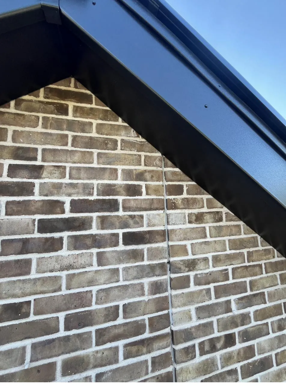 Brick apex before sealant, open gap along the roofline