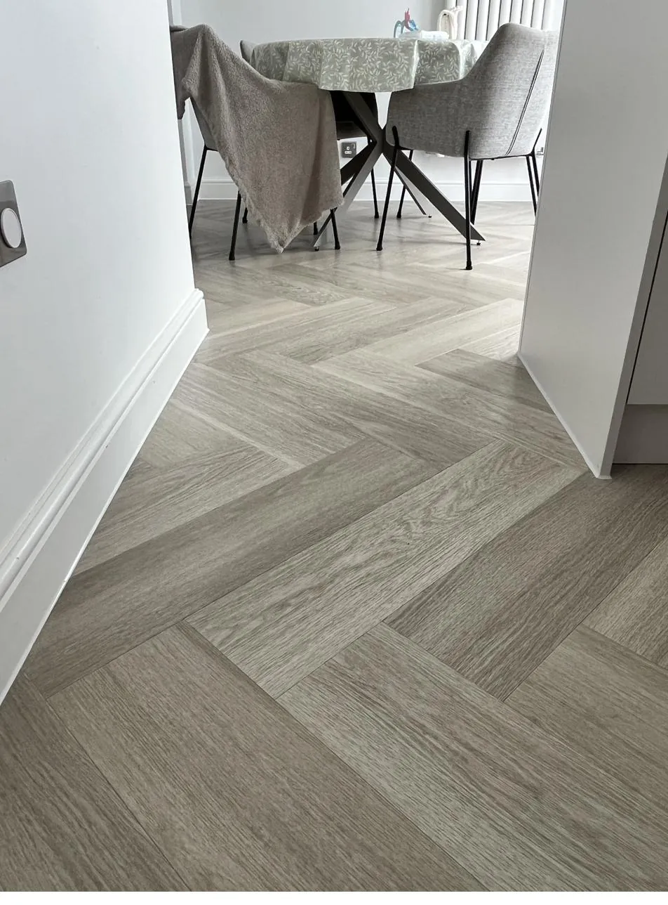 Skirting board sealed neatly against herringbone flooring