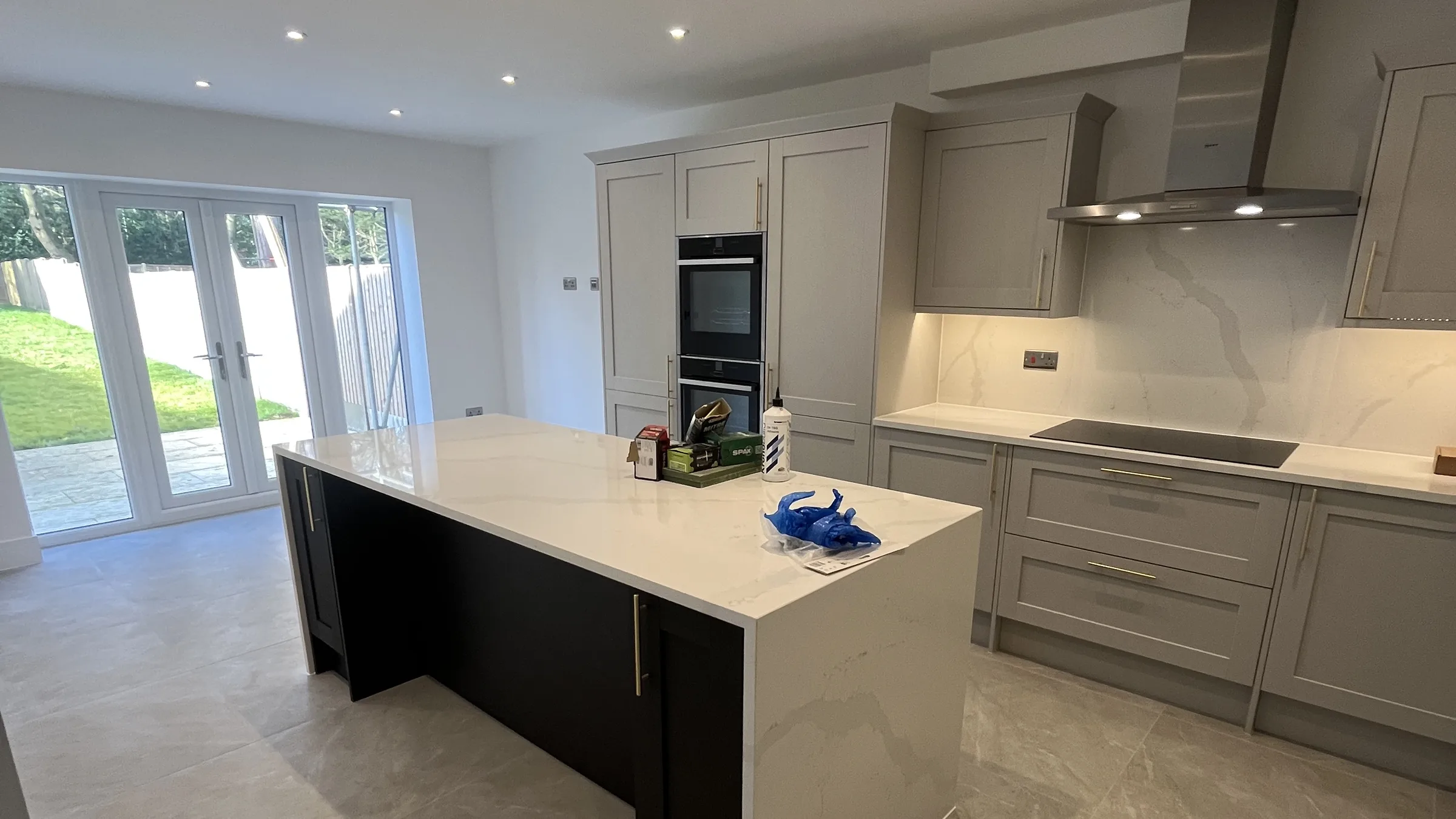 Modern grey shaker kitchen with quartz island, sealed worktop and splashback joints, finished by Apex Sealants