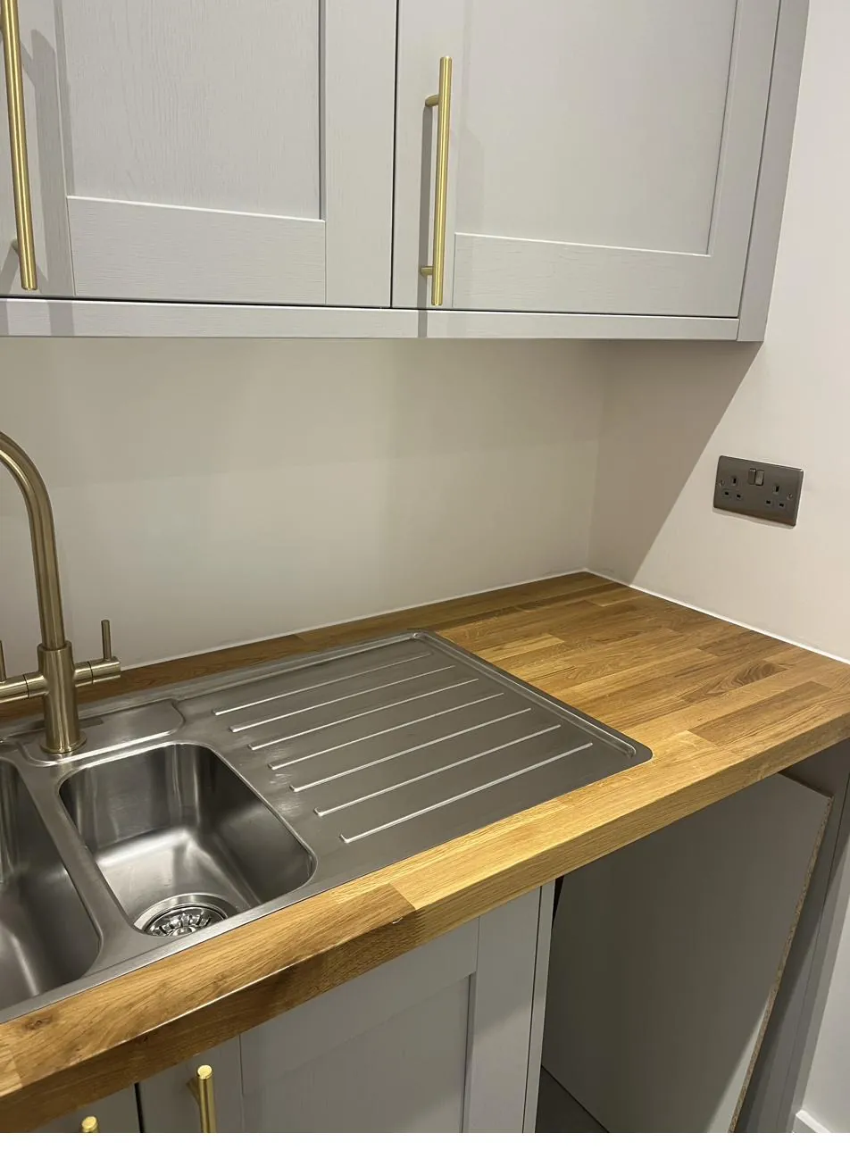 Close-up of wood worktop sealed against wall in a utility room